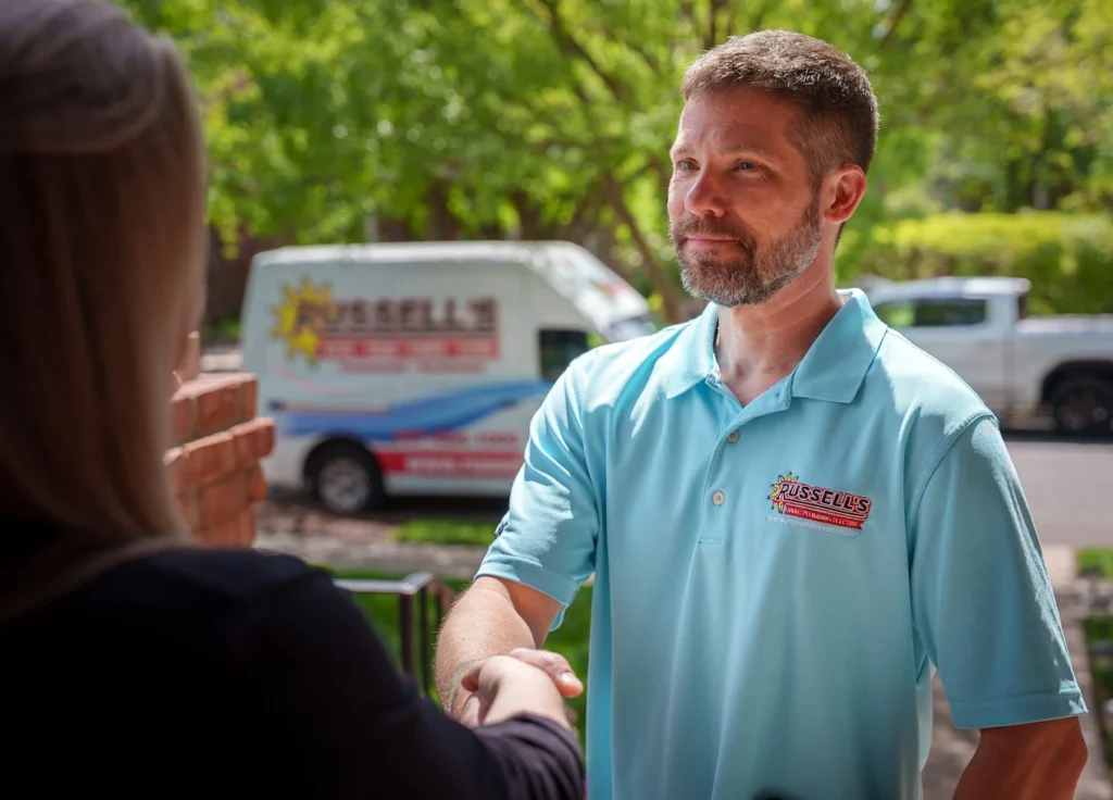 Russell's technician shaking hands with a customer
